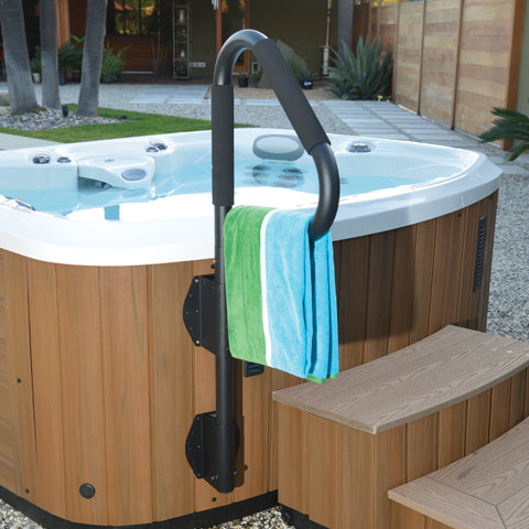 Handrail attached to the side of a spa tub with a towel hanging on it, showing a spa environment.