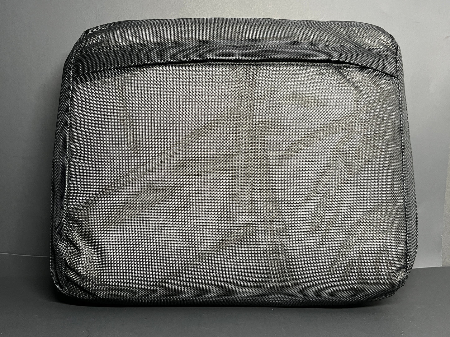 Bottom Side of Water Brick (black) spa booster seat, showing the zipper access to the interior cushion.